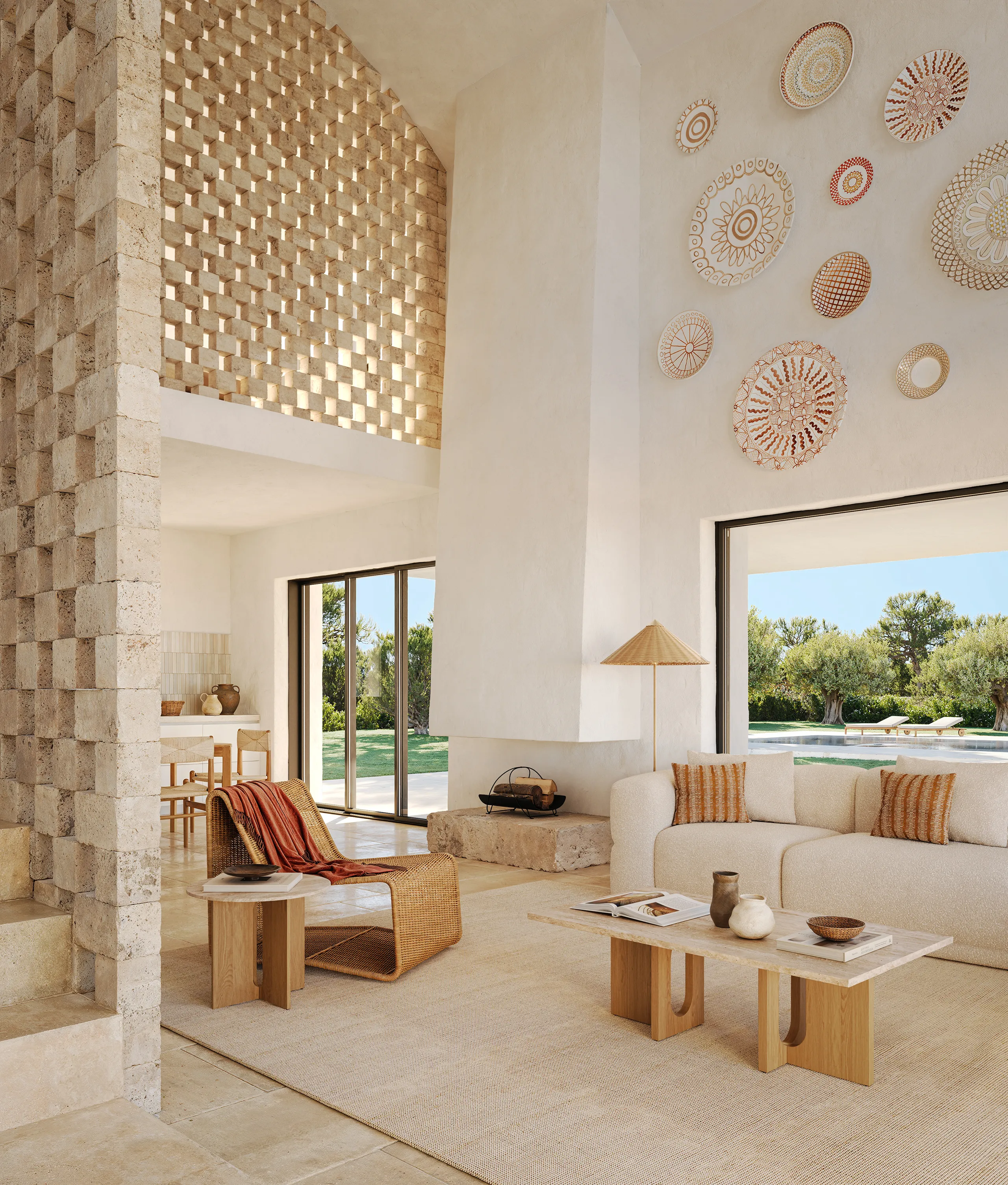 Living room at Lamalunga Villa featuring natural materials, floor-to-ceiling glazing and seamless indoor-outdoor living.